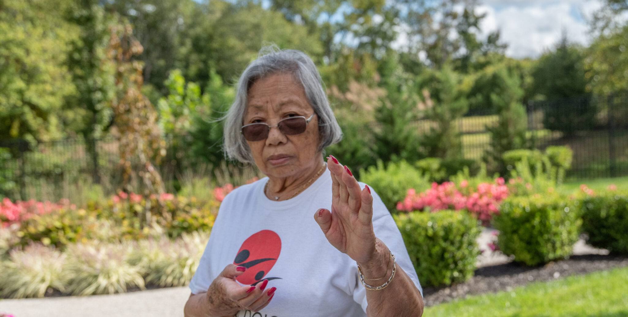 senior resident tae kwon do moves in garden area