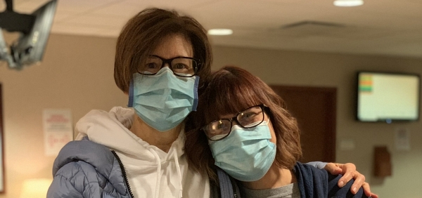 senior mom and daughter in masks